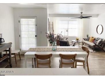 Bright dining area features a white table with seating, seamlessly connecting to the open-concept living space at 20 S Buena Vista Ave # 111, Gilbert, AZ 85296