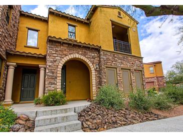 Charming multi-story home featuring stone accents, a cozy balcony, and inviting curb appeal at 20750 N 87Th St # 2115, Scottsdale, AZ 85255