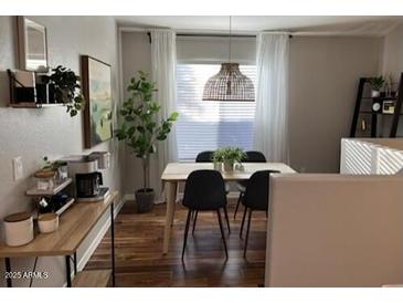 Bright dining room featuring a modern light fixture, dining set, and contemporary design elements at 2150 E Bell Rd # 1068, Phoenix, AZ 85022