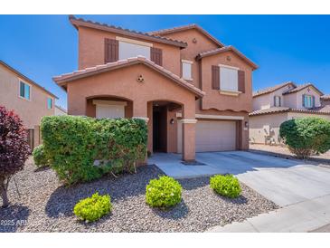 Charming two-story home featuring a two-car garage and well-maintained landscaping under a clear blue sky at 316 N 78Th Pl, Mesa, AZ 85207