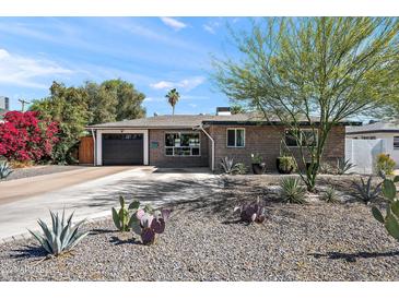 Charming single-story home with desert landscaping, covered front entry, and a spacious driveway leading to garage at 3837 E Yale St, Phoenix, AZ 85008