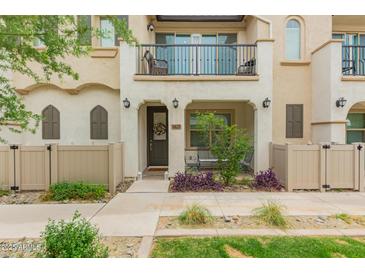 Charming two-story townhome featuring a welcoming front porch and upper-level balcony at 4637 S Jetty --, Mesa, AZ 85212