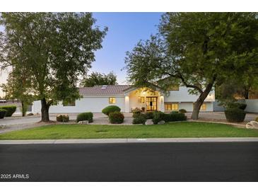 Charming single-Gathering home with a well-maintained front yard and mature shade trees at 5202 E Larkspur Dr, Scottsdale, AZ 85254