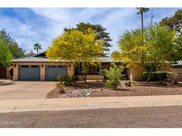Charming single-story home with desert landscaping and a spacious two-car garage and sidewalk at 7202 N 16Th Dr, Phoenix, AZ 85021