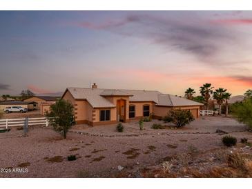 Inviting single-story home featuring a well-manicured front yard and neutral-toned exterior at sunset at 8351 S Summit Dr, Casa Grande, AZ 85193
