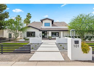 Stunning white home featuring a modern design, desert landscaping, and a welcoming walkway at 101 E Linger Ln, Phoenix, AZ 85020