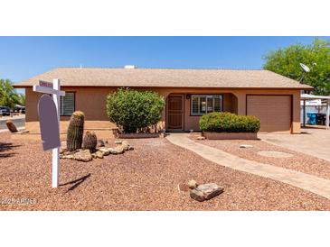 Charming single-story home featuring desert landscaping, a brick walkway, and an attached garage at 2302 E Monte Cristo Ave, Phoenix, AZ 85022