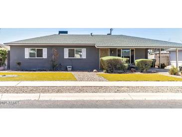 Charming single-story home with manicured front yard and mature landscaping at 2715 E Edgemont Ave, Phoenix, AZ 85008