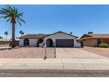 Single-story home with a well-maintained front yard, desert landscaping, and a two-car garage at 3765 W Wood Dr, Phoenix, AZ 85029