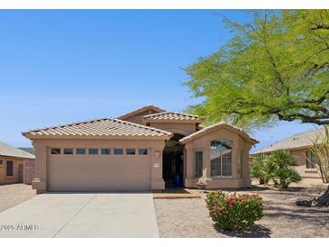 Charming single-story home with a tile roof, desert landscaping, and a two-car garage, exuding curb appeal at 17141 E Rockwood Dr, Fountain Hills, AZ 85268