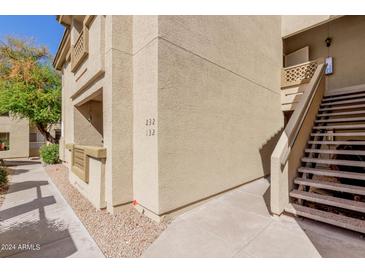 View of the exterior of the building with stairs leading up to the units at 1880 E Morten Ave # 125, Phoenix, AZ 85020