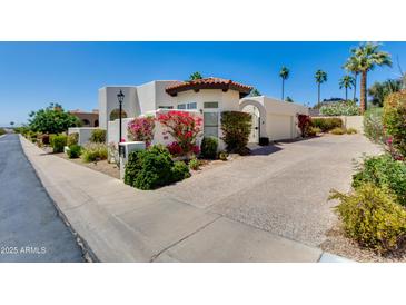 Charming stucco home with lush landscaping, red tile roof, and inviting curb appeal at 2132 E Northview Ave, Phoenix, AZ 85020