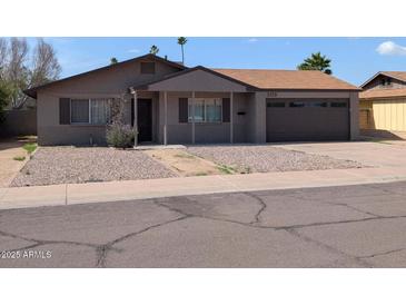 Charming single-story home with gravel landscaping and a two-car garage at 2179 E Palmcroft Dr, Tempe, AZ 85282