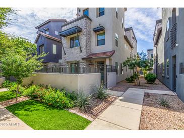 Beautiful home exterior with manicured lawn and garden, plus inviting walkway at 300 N Gila Springs Blvd # 181, Chandler, AZ 85226