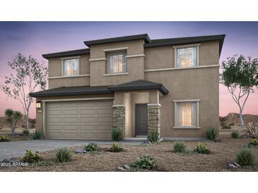 Two story home featuring a two car garage, stucco finish, and stone accents at 42950 W Palo Amarillo Rd, Maricopa, AZ 85138