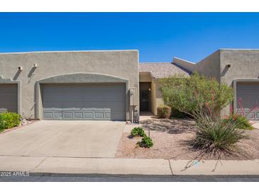 Charming home featuring a two-car garage, desert landscaping, and a quaint front entrance at 64 N 63Rd St # 55, Mesa, AZ 85205
