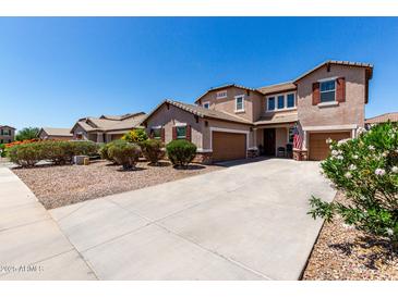 Charming two-story home with a well-manicured yard and a long driveway to two-car garage at 868 W Desert Glen Dr, San Tan Valley, AZ 85143