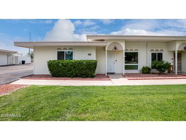 Charming single-story home with a well-manicured lawn and inviting front entrance at 14224 N Newcastle Dr, Sun City, AZ 85351