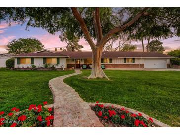 Charming single-story home with lush lawn, brick walkway, and mature shade tree at 1831 E Rovey Ave, Phoenix, AZ 85016
