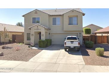 Charming two-story home featuring manicured landscaping and an attached two-car garage at 18629 W Fulton St, Goodyear, AZ 85338