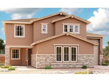 Charming two-story home featuring stone accents and a well-manicured front yard under a partly cloudy sky at 20516 S 216Th Pl, Queen Creek, AZ 85142