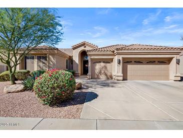 Charming single-story home with a well-manicured yard, three-car garage, and lovely desert landscaping at 22634 N 47Th Pl, Phoenix, AZ 85050