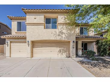 Inviting two-story home featuring a neutral color palette, three-car garage, and well-maintained landscaping at 28054 N Jade St, San Tan Valley, AZ 85143