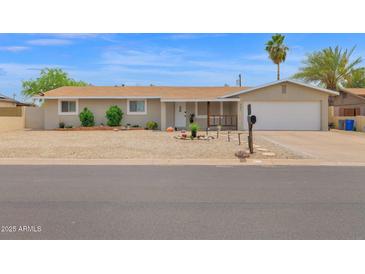 Charming single-story home with desert landscaping, a covered porch, and an attached two-car garage at 301 N 87Th St, Mesa, AZ 85207