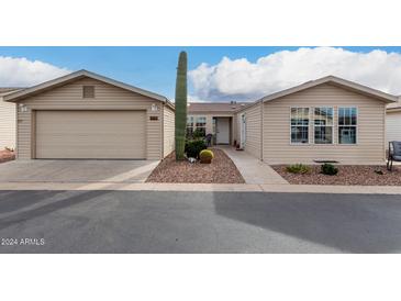Inviting single-story home featuring low maintenance landscaping and an attached two-car garage at 3301 S Goldfield Rd # 1046, Apache Junction, AZ 85119