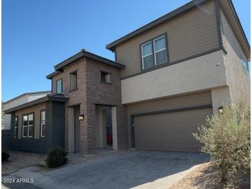 Two-story home featuring mixed brick and siding exterior and an attached two car garage at 359 N 157Th Ln, Goodyear, AZ 85338