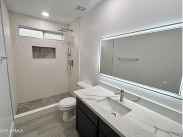 A modern bathroom is equipped with sleek fixtures and updated tile at 22261 W Tonto St, Buckeye, AZ 85326