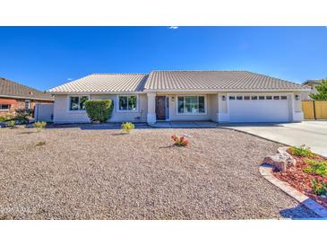 Single-story home with a tile roof and desert landscaping on a sunny day at 2317 E Lynwood St, Mesa, AZ 85213