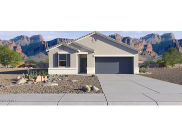 New construction home with a well-manicured xeriscaped front yard, 2-car garage and mountain backdrop at 35556 N Common Ct, San Tan Valley, AZ 85140