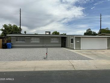 Charming single-story home with a well-kept gravel front yard and attached two-car garage at 3608 W Hazelwood St, Phoenix, AZ 85019