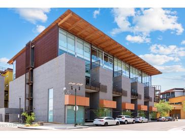 Contemporary condo building with a wood overhang, concrete construction, large windows and a stylish facade at 4747 N Scottsdale Rd # 4003, Scottsdale, AZ 85251