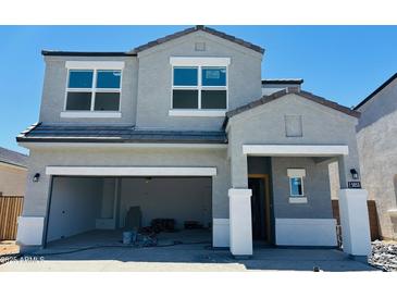 Two story home featuring an attached garage and neutral-colored stucco at 5053 E Umber Rd, San Tan Valley, AZ 85143