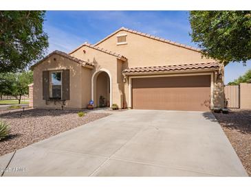 Charming single-story home featuring a tile roof, a two-car garage and low maintenance desert landscaping at 6482 S Claiborne Ave, Gilbert, AZ 85298