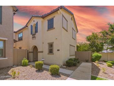Inviting two-story home with desert landscaping and charming architectural details at 8313 E Impala Ave, Mesa, AZ 85209