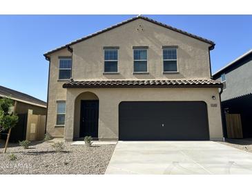 Inviting two-story home with a two car garage and neat landscaping at 13282 E Verbina Ln, Florence, AZ 85132