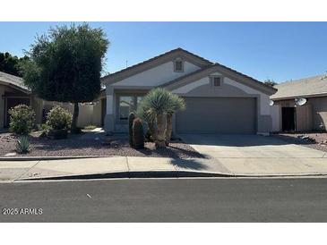 Charming single-story home featuring desert landscaping and a two-car garage at 21192 N 80Th Ln, Peoria, AZ 85382