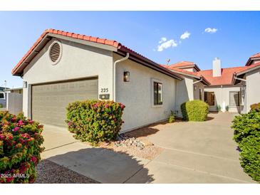 Charming single-story home showcasing a well-maintained yard, red tile roof and stucco facade at 225 S Pioneer -- # 36, Mesa, AZ 85204