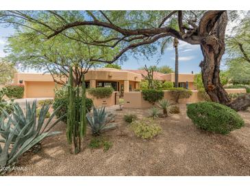 Charming single-story home with desert landscaping, mature trees, and a red tile roof at 23240 N Country Club Trl, Scottsdale, AZ 85255