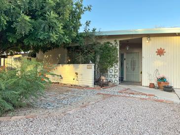 Charming home exterior with desert landscaping, walkway, and privacy wall in a quiet residential neighborhood at 3231 N 81St Pl, Scottsdale, AZ 85251