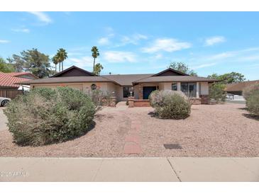 Charming single-story home featuring a desert-landscaped front yard and red brick accents at 350 E Huber St, Mesa, AZ 85201
