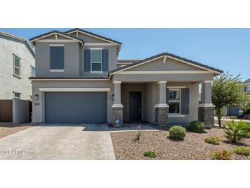 Charming two-story home with a well-manicured front yard and a gray exterior paint at 5109 E Helena Dr, Scottsdale, AZ 85254