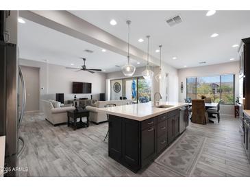 Spacious open-concept living space with a seamless flow between the kitchen and living room at 8040 E Jaeger St, Mesa, AZ 85207
