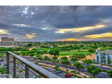 View of lush golf course from balcony with beautiful sunset views, manicured grounds, and green fairways at 15215 N Kierland Blvd # 636, Scottsdale, AZ 85254