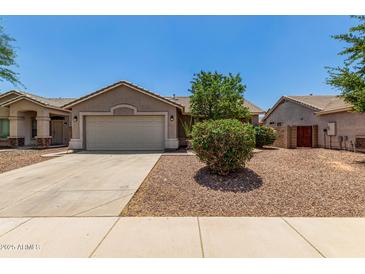 Charming single-story home with a well-manicured, low-maintenance desert landscape and a two car garage at 2191 W Goldmine Mountain Dr, Queen Creek, AZ 85144