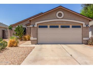 Single-story home featuring a two-car garage and low-maintenance desert landscaping at 22056 N 32Nd Ave, Phoenix, AZ 85027