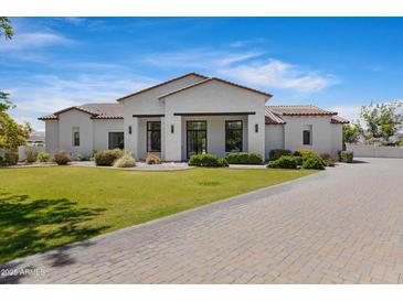 Beautiful single-Gathering home featuring a manicured lawn, brick driveway, and modern exterior at 24434 S 201St Ct, Queen Creek, AZ 85142